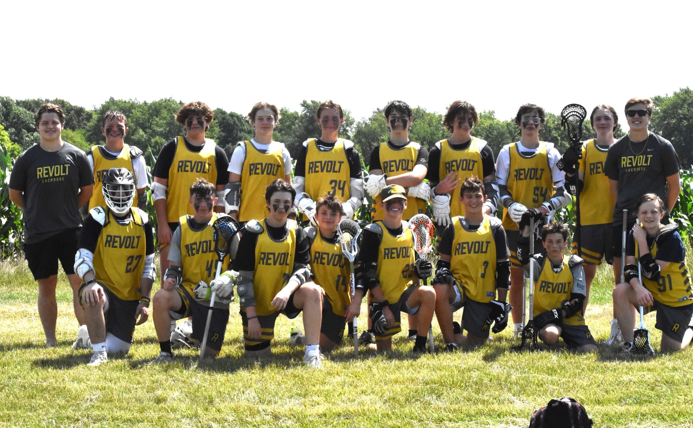 The Revolt LC roster in gold pinnies, gathered on the field for a team photo